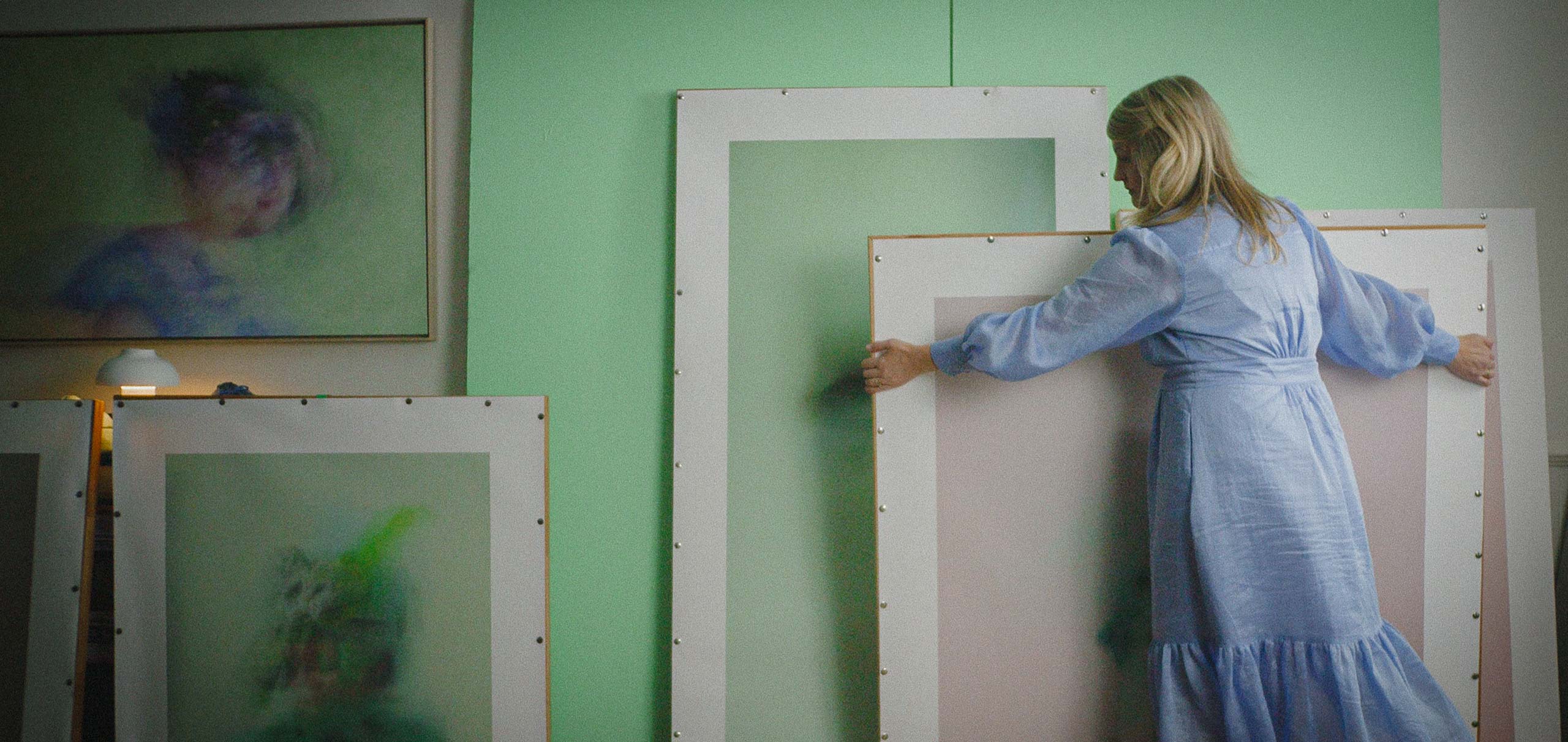 Marisa Veerman moves canvases in her studio
